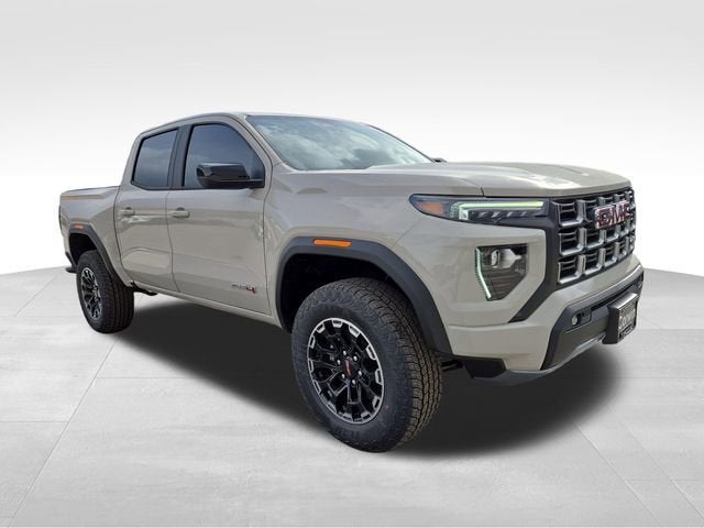 2026 GMC Canyon AT4 in Coastal Dune — front three-quarter view